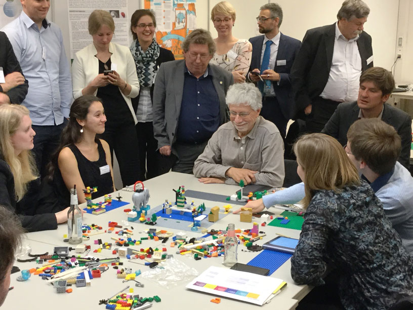 People standing around table with LEGO Serious Play